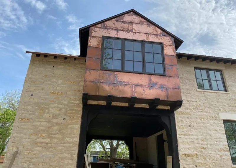 Copper metal panel facade on a stone building for Roof Repair in Parker